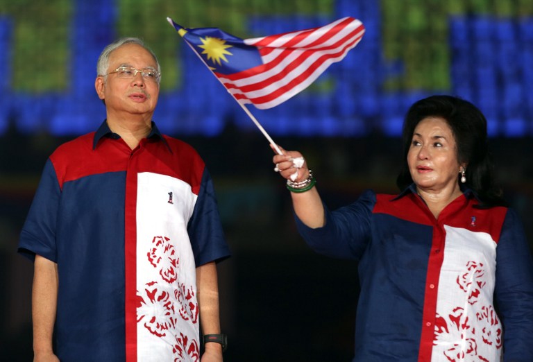 Prime Minister Datuk Seri Najib Razak looks on as his wife Datin Seri Rosmah Mansor waves a  flag during a rally to celebrate country's 55th Independence Day in Bukit Jalil Stadium,  August 31, 2012. u00e2u20acu201c AFP pic