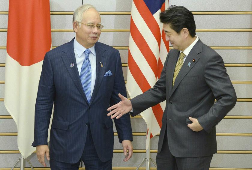 Japan's Prime Minister Shinzo Abe welcomes Datuk Seri Najib Razak before their talks at Abe's official residence in Tokyo December 12, 2013. Najib is here to attend summit meetings between Japanese and Asean leaders. u00e2u20acu201d Reuters pic