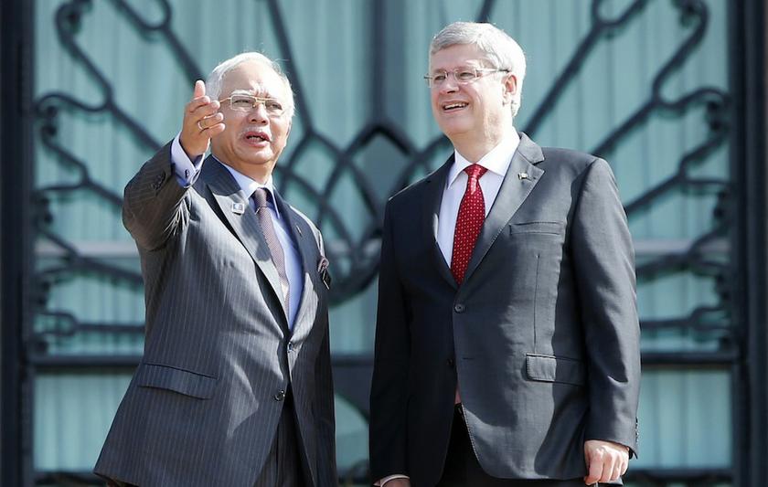 Prime Minister Datuk Seri Najib Razak speaks to Canadau00e2u20acu2122s Prime Minister Stephen Harper during a photo call outside Najibu00e2u20acu2122s office in Putrajaya October 6, 2013. u00e2u20acu201d Reuters pic