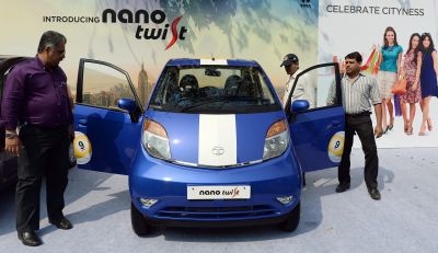 Indian visitors inspect the new Nano Twist motor-car after the launch in Mumbai. u00e2u20acu2022 AFP pic