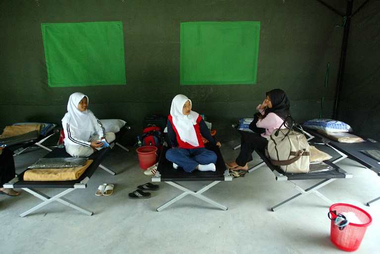 Female students sit in their tent on the first day of the National Service Program at a camp in Kuala Kubu Baru outside of Kuala Lumpur 16 February 2004. u00e2u20acu201du00c2u00a0AFP pic