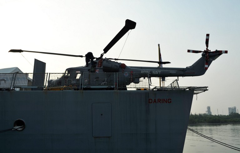 A British navy sailor works on an AW159 Agusta Westland helicopter on the British Royal Navy destroyer HMS Daring, the first of the Royal Navy's new Type 45 destroyers in Port Klang, outside Kuala Lumpur on January 24, 2014. u00e2u20acu201du00c2u00a0AFP pic