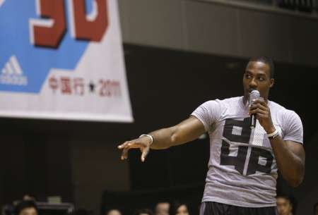 NBA basketball player Dwight Howard of Orlando Magic gestures to his fans at a promotional event during his China tour in Wuhan, Hubei province on September 4, 2011. u00e2u20acu201d Reuters pic