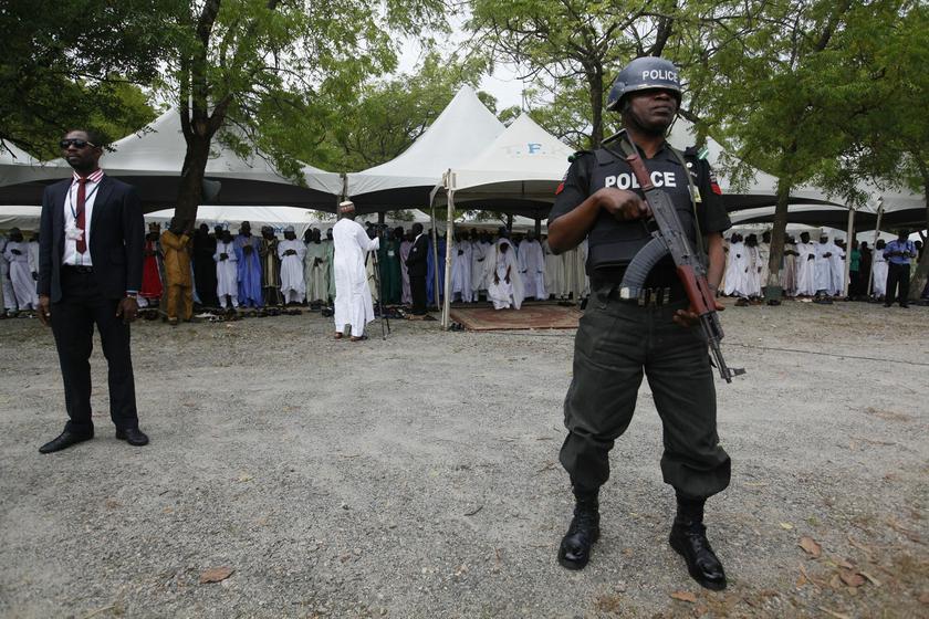 A police officer stands guard as Muslims pray at a prayer ground in Abuja October 15, 2013. u00e2u20acu201d Reuters pic