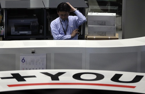 An employee of the Tokyo Stock Exchange (TSE) works at the bourse in Tokyo June 13, 2013. u00e2u20acu201d Reuters pic