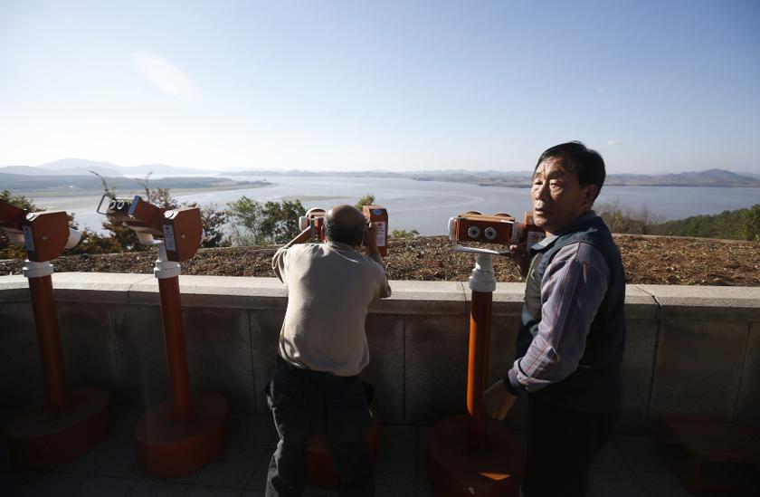 A man looks towards North Korea's propaganda village Kaepoong through a pair of binoculars at the Unification Observation Platform, near the demilitarised zone which separates the two Koreas, in Paju, north of Seoul October 16, 2013. u00e2u20acu201d Reuters pic