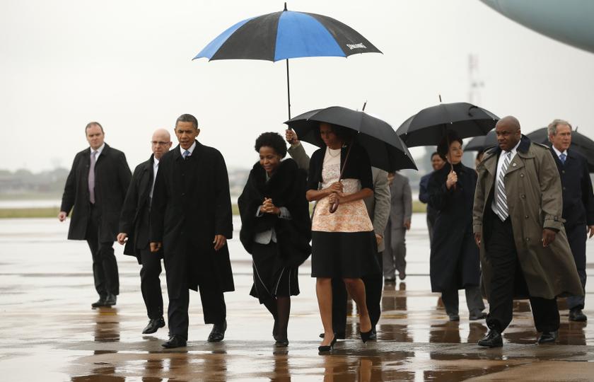 US President Barack Obama (3rd left) and first lady Michelle Obama (centre) are escorted upon their arrival on Air Force One to attend a memorial service for Nelson Mandela at FNB Stadium in Johannesburg December 10, 2013. u00e2u20acu201d Reuters pic