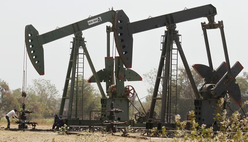 A worker examines the valve of a pump on an Oil and Natural Gas Corp (ONGC) well on the western Indian city of Ahmedabad March 1, 2012. u00e2u20acu201c Reuters pic