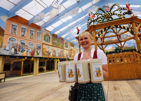A waitress presents the official Oktoberfest beer mug during a presentation in Munich August 27, 2013. The Oktoberfest, the worldu00e2u20acu2122s biggest beer festival, runs from September 21 until October 6 this year. u00e2u20acu201d Reuters pic