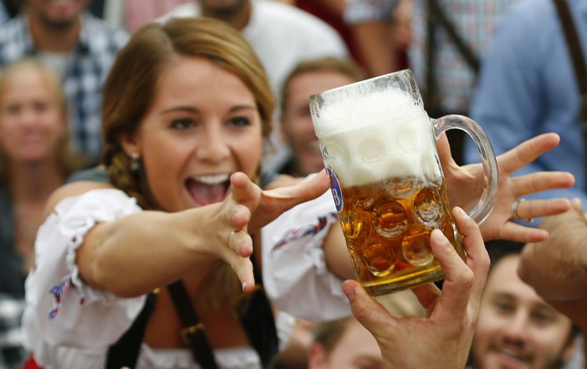 A visitor reaches for of the one of the first mugs of beer after the tapping of the first barrel at opening ceremony for the 180th Oktoberfest at the Hofbraeu tent in Munich, Sept 21, 2013. u00e2u20acu201d Reuters pic
