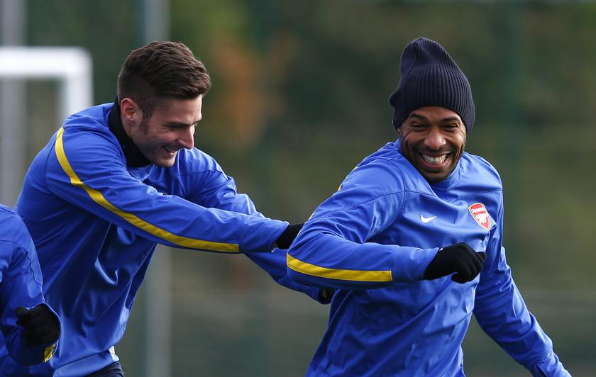 Arsenal's Olivier Giroud (left) pushes Thierry Henry of the New York Red Bulls during a team training session at their training ground in London Colney, north of London, November 25, 2013. u00e2u20acu201d Reuters pic
