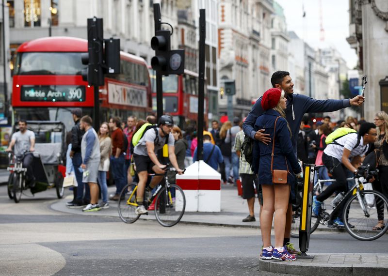 A couple take a selfie as commuters travel home through Oxford Circus during a 24-hour strike by underground rail workers in London, Britain August 5, 2015. u00e2u20acu201d Reuters pic