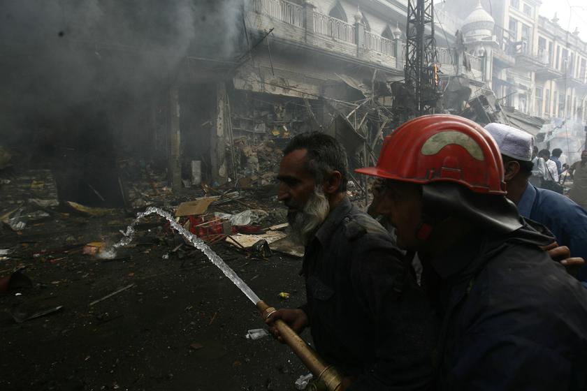 Firefighters extinguish a fire at the site of a bomb attack in Peshawar September 29, 2013. Twin blasts in the northwestern Pakistan city of Peshawar killed 33 people and wounded 70 today. u00e2u20acu201d Reuters pic