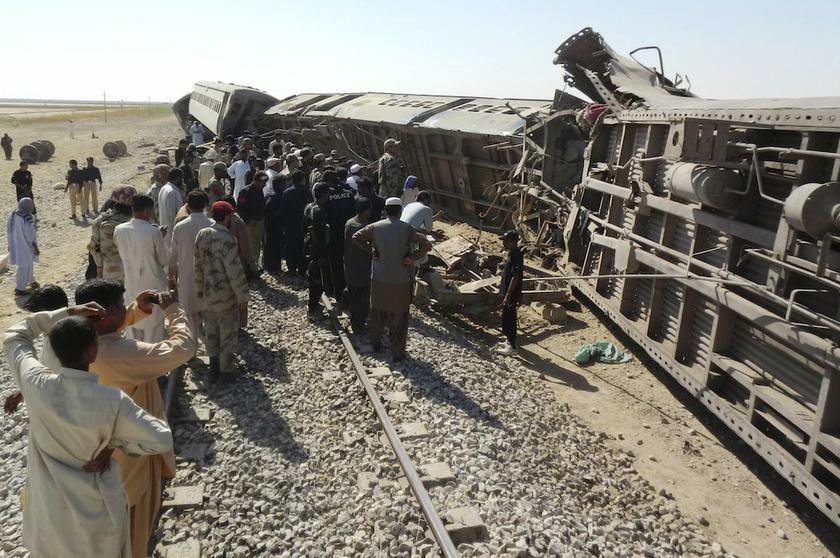 Officials, rescue workers and residents gather near the passenger train derailed after it was hit by a bomb attack in Dera Murad Jamali, in the Nasirabad District of Balochistan province, October 21, 2013. u00e2u20acu201d Reuters pic