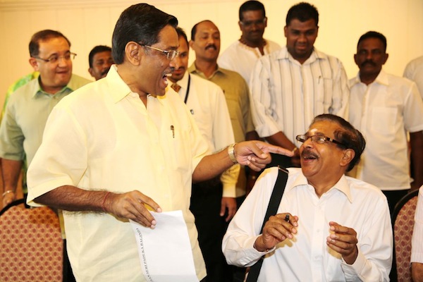 Datuk Seri G.Palanivel and Datuk Seri Dr S.Subramaniam share a light moment before submitting their nomination forms for the MIC presidential election in Kuala Lumpur, September 1, 2013. u00e2u20acu201d Picture by Choo Choy May