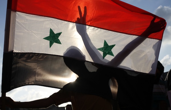 Palestinian protesters hold a Syrian flag during a demonstration in Rafah, in the southern Gaza Strip, against potential strikes on the Syrian government September 3, 2013. u00e2u20acu201d Reuters pic