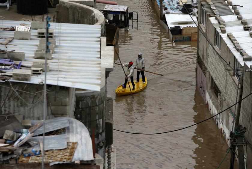 Members of Palestinian civil defence ride a boat as they proceed to evacuate people from their houses which were flooded with rainwater on a stormy day in Gaza City December 13, 2013. u00e2u20acu201d Reuters pic