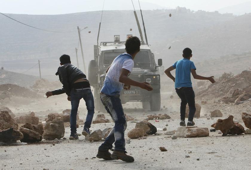 Palestinian youths throw stones at Israeli army jeeps during clashes following a confrontation between Palestinians and Jewish settlers, in the West Bank village of Qusra, near Nablus November 18, 2013. u00e2u20acu201d Reuters pic