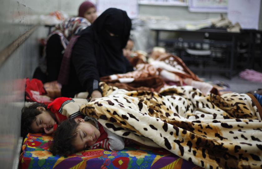 A Palestinian child sleeps on a mattress at a school, after being evacuated from his house that is flooded with rainwater, on a stormy day in Khan Younis in the southern Gaza Strip December 14, 2013. u00e2u20acu201d Reuters pic