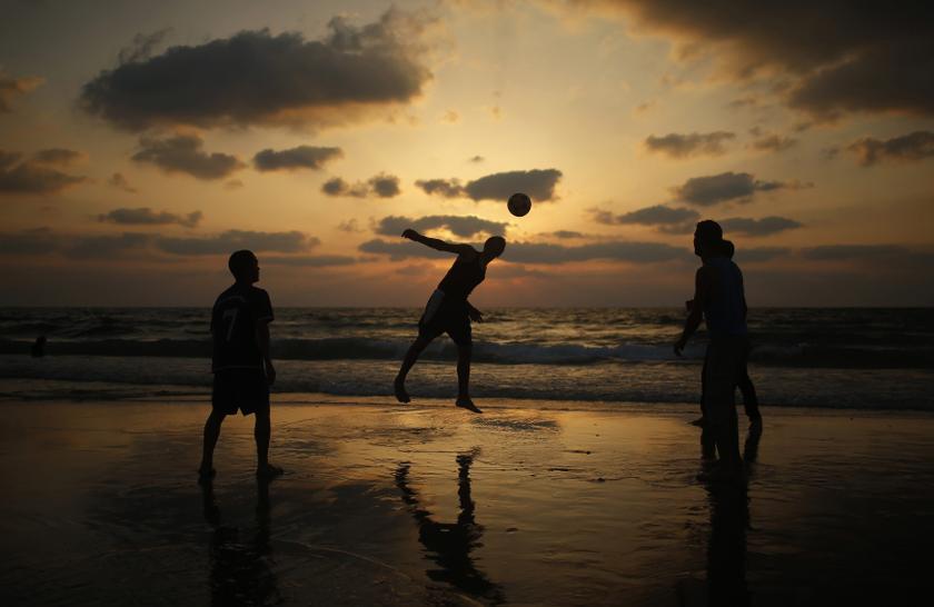 Palestinian children play football on the beach in Gaza City July 9, 2013. u00e2u20acu201d Reuters pic
