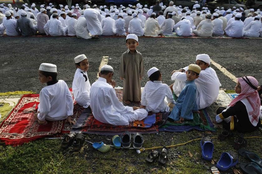A Muslim boy stands before a prayer session during the celebration of Eid al-Fitr at the Santa Maria La Antigua University car park in Panama City August 9, 2013. u00e2u20acu201c Reuters pic