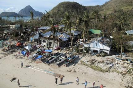 An aerial view shows damaged houses, as residents wave for help after Typhoon Haiyan hit a village in Panay island, in northern Iloilo Province, central Philippines November 9, 2013.