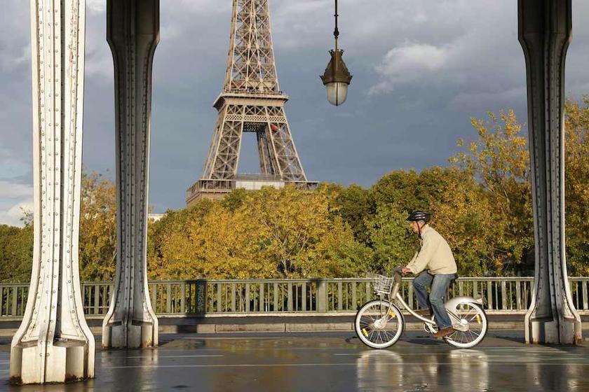 A man rides a Velib self-service public bicycle under an elevated metro line near the the Eiffel Tower after a brief rain shower in Paris October 26, 2013. u00e2u20acu201d Reuters pic