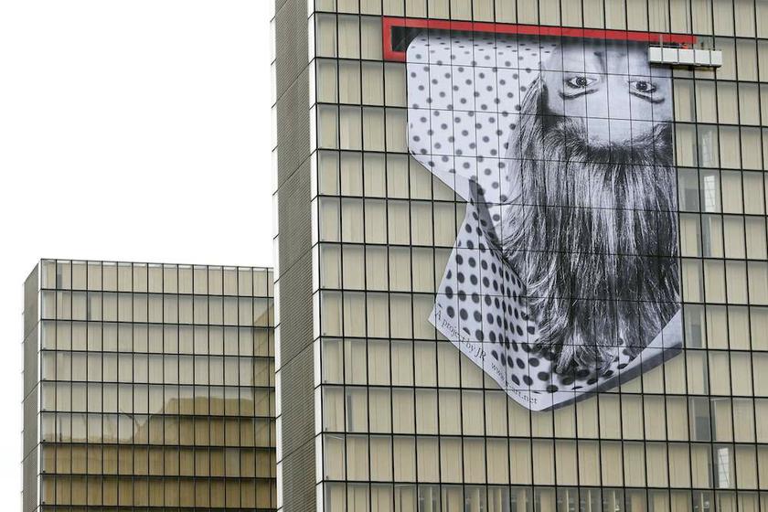 A giant upside down portrait made of paper strips covers the facade of the French National Library (BNF) in Paris as part of a temporary exhibition by French photographer and street artist JR on November 8, 2013. u00e2u20acu201d Reuters pic