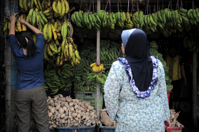 Shoppers shop for fruits at a stall in Ampang, in the suburbs of Kuala Lumpur on February 3, 2014. u00e2u20acu201d AFP pic