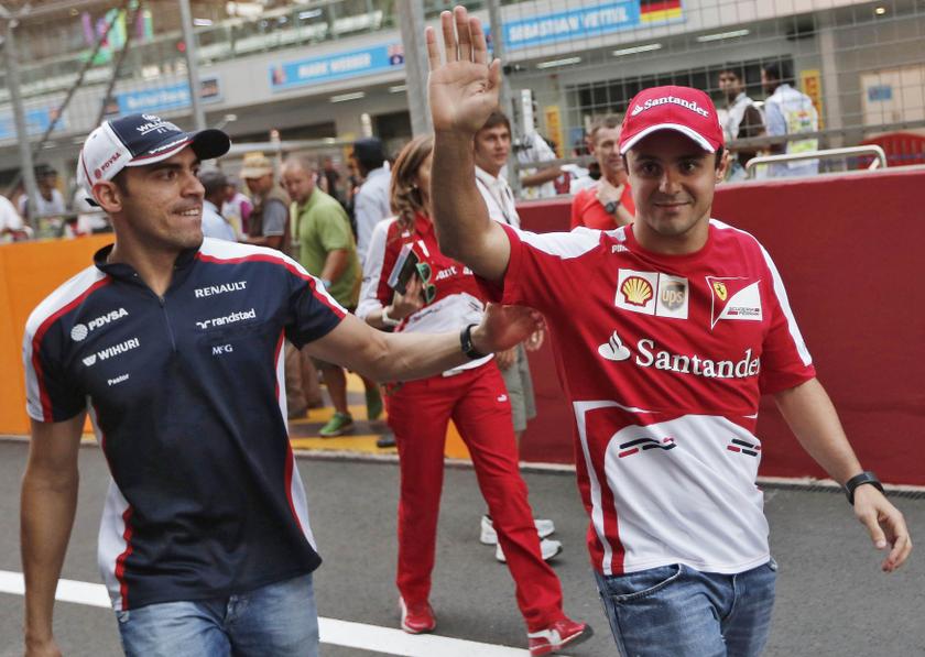 Ferrari Formula One driver Felipe Massa of Brazil waves to fans next to Williams driver Pastor Maldonado (left) of Venezuela at the Buddh International Circuit in Greater Noida on the outskirts of New Delhi October 24, 2013. u00e2u20acu201d Reuters pic