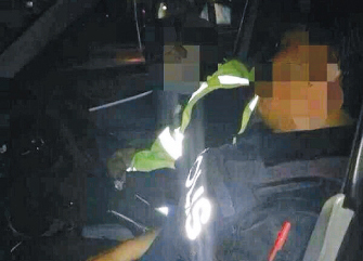 The on-duty cops take 40 winks in their patrol car after a beer session.