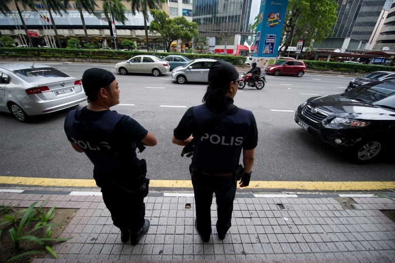 This picture taken on September 19, 2013 shows Malaysian special policemen standing during a press conference called 'Op Cantas Khas' outside a shopping mall in downtown Kuala Lumpur. u00e2u20acu201d AFP pic