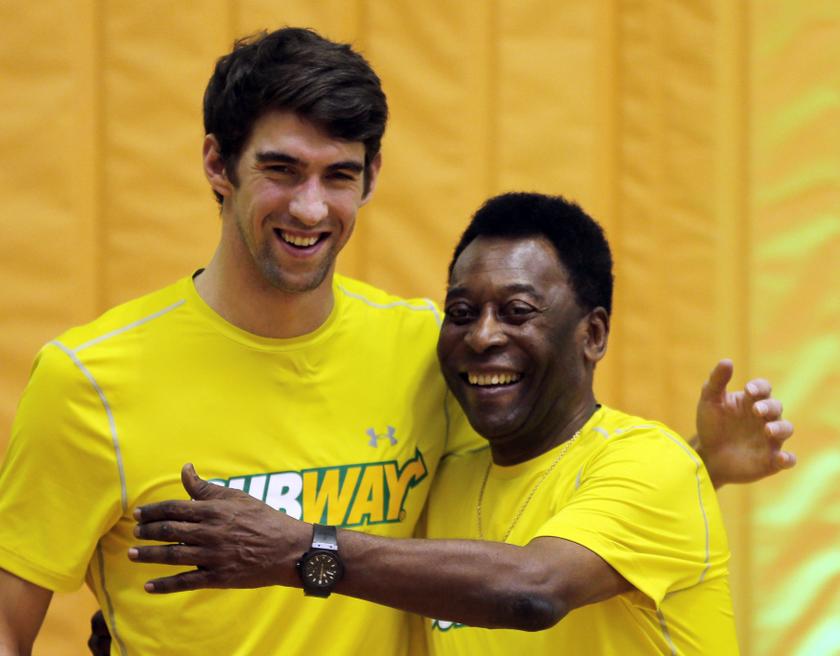 US swimmer Michael Phelps (left) embraces Brazil football legend Pele during a promotional event in Sao Paulo December 4, 2013. u00e2u20acu201d Reuters pic