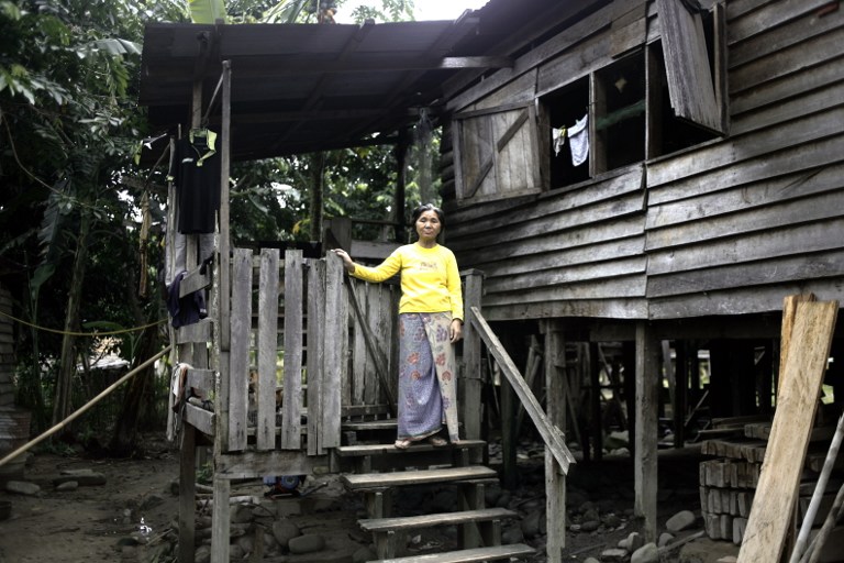 Ganiet Nyato of Malaysia's Penan tribe standing on the stairs of her house in Long Bubui in Malaysia's Sarawak state. u00e2u20acu201d AFP pic