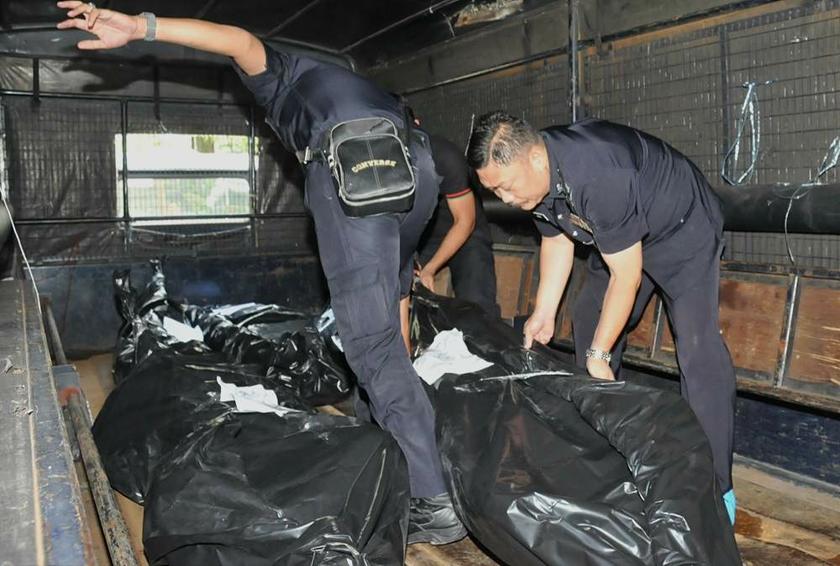 Police removing the bodies of five alleged gangsters killed in a shootout with police in Penang earlier this week. u00e2u20acu201d Picture by K.E. Ooi