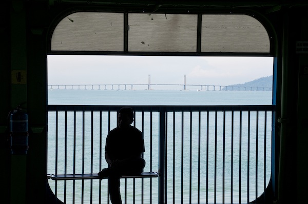 A ferry passenger is silhouetted against the Penang Bridge as Penang enjoys clear skies September 2, 2013. u00e2u20acu201d Picture by K.E. Ooi