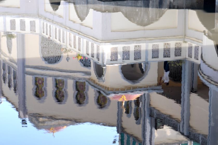The reflection of a mosque helper is seen in the sea as he carries out some maintenance work at the Tanjung Bungah floating mosque in George Town February 11, 2014. u00e2u20acu201d Picture by K.E. Ooi