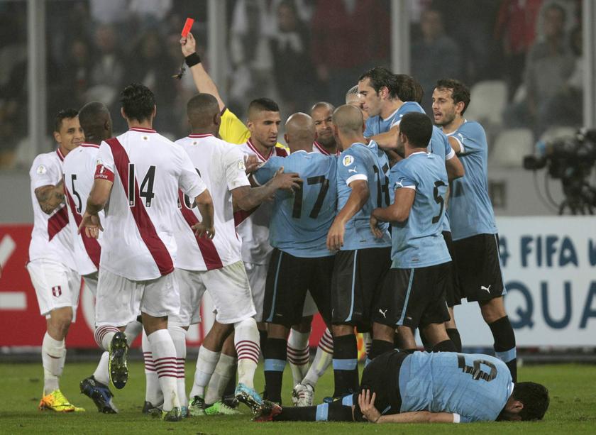 Peru and Uruguay players scuffle after the referee sends off Peru's Victor Yotun (not pictured) with a red card during their 2014 World Cup qualifying match in Lima, September 6, 2013. u00e2u20acu201d Reuters pic