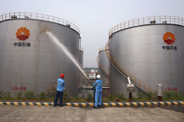 Employees spray water to cool down oil tanks at a storage facility, which belongs to one of Chinau00e2u20acu2122s biggest state-owned firms PetroChina oil, in Suijing, Sichuan Province, in this August 13, 2010 file photo. u00e2u20acu201d Reuters pic