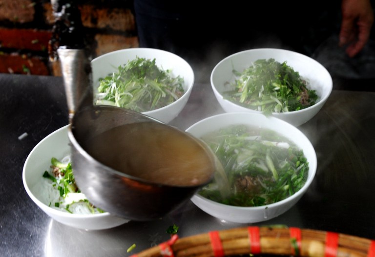 This picture taken on January 10, 2013 shows bowls of pho noodle being prepared at Pho Thin restaurant in Hanoi. u00e2u20acu201d AFP pic