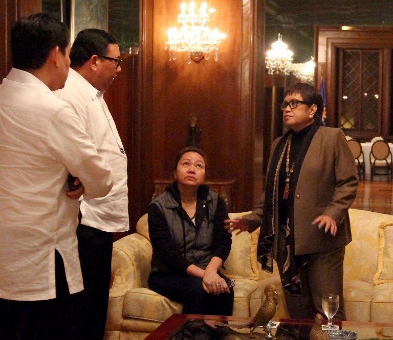 Handout photo released by Malacanang Photo Bureau (MPB) on August 29, 2013 shows Janet Napoles, a Philippine businesswoman who allegedly connived with legislators to embezzle 10 billion pesos intended for development projects. Her lawyer Lorna Kapunan (R)