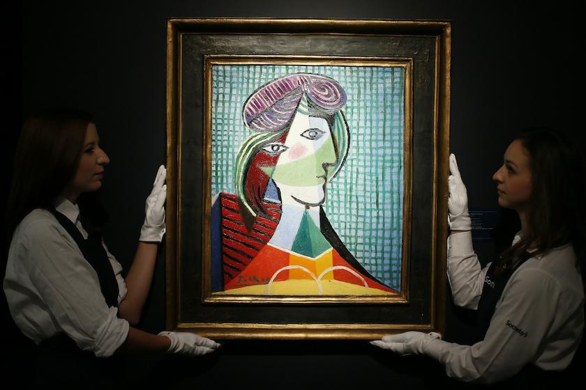 Sotheby's employees pose with Pablo Picasso's artwork u00e2u20acu02dcTete de femmeu00e2u20acu2122 in London October 11, 2013. u00e2u20acu201d Reuters pic