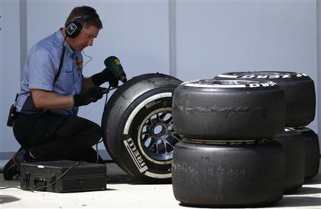 A Pirelli technician works on a tyre during the British Grand Prix at the Silverstone Race circuit in England on June 30, 2013. u00e2u20acu201d Reuters pic