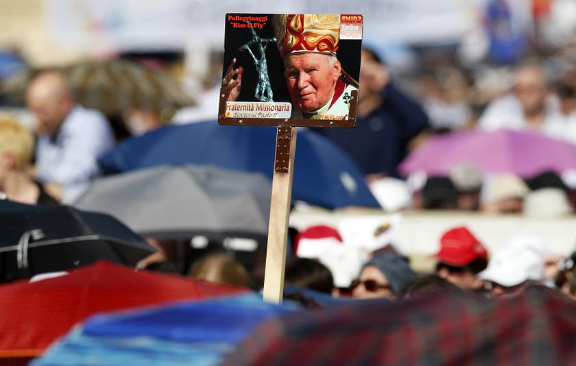 Faithful hold a poster of the late Pope John Paul II as Pope Francis leads a Pentecost vigil mass in Saint Peter's Square at the Vatican May 18, 2013. u00e2u20acu201d Reuters pic