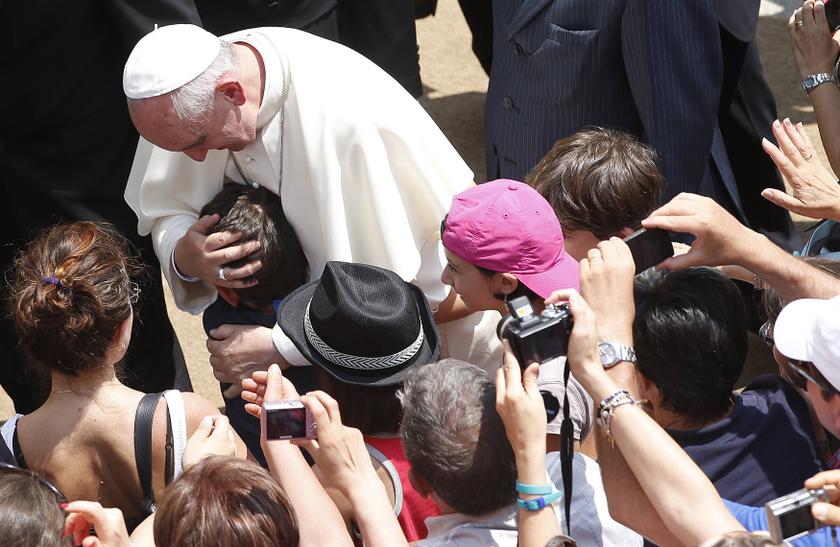 Pope Francis embraces a boy at the end of Sunday Angelus prayer from the summer residence in Castel Gandolfo July 14, 2013. u00e2u20acu201c Reuters pic