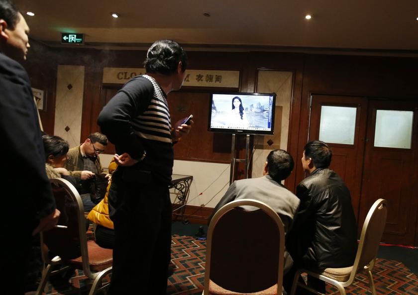 Family members of passengers aboard the missing Malaysia Airlines Flight MH370 wait in front of a TV screen at a hotel in Beijing March 15, 2014. u00e2u20acu201d Reuters pic