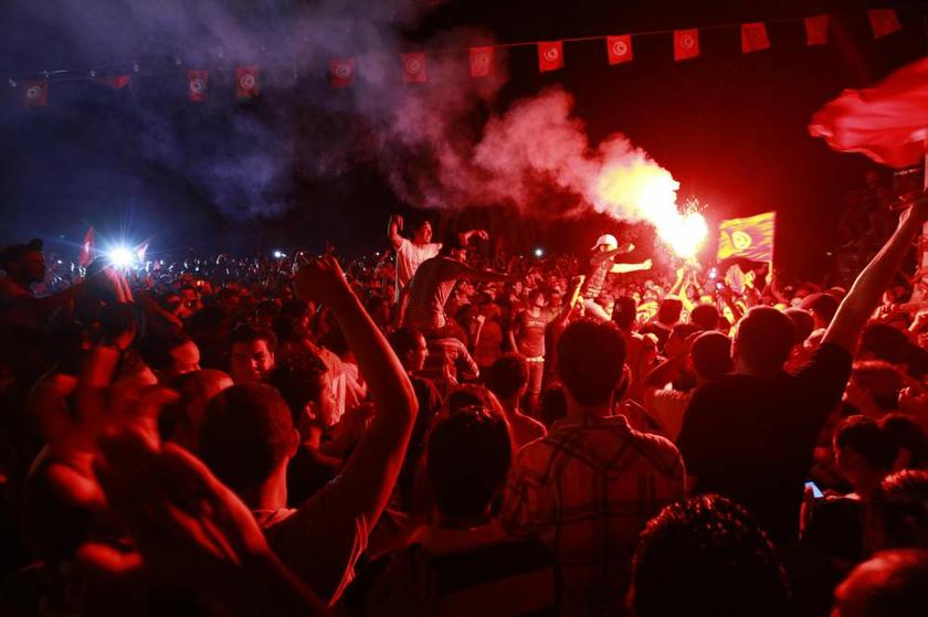 A Tunisian demonstrator holds a lighted flare during a protest to demand the ouster of the Islamist-dominated government, outside the Constituent Assembly headquarters in Tunis on July 28, 2013. u00e2u20acu201d Reuters pic