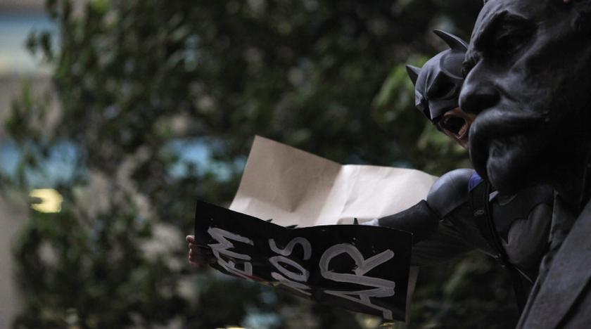 A demonstrator dressed as comic book superhero Batman hangs on a statue during a protest against the government and the police in Rio de Janeiro November 5, 2013. u00e2u20acu201d Reuters pic