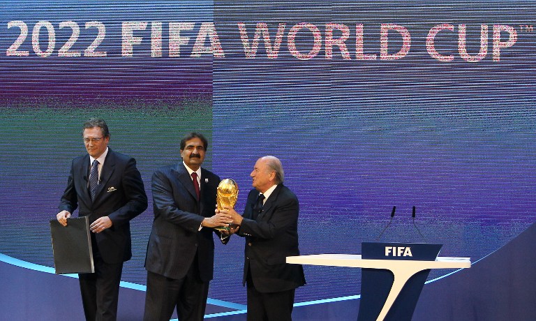 Qatar's Emir Sheikh Hamad bin Khalifa al-Thani (centre) holds the World Cup trophy with FIFA president Joseph Blatter (right) after Qatar was chosen to host the 2022 World Cup at the FIFA headquarters in Zurich on December 2, 2010. u00e2u20acu201d AFP pic