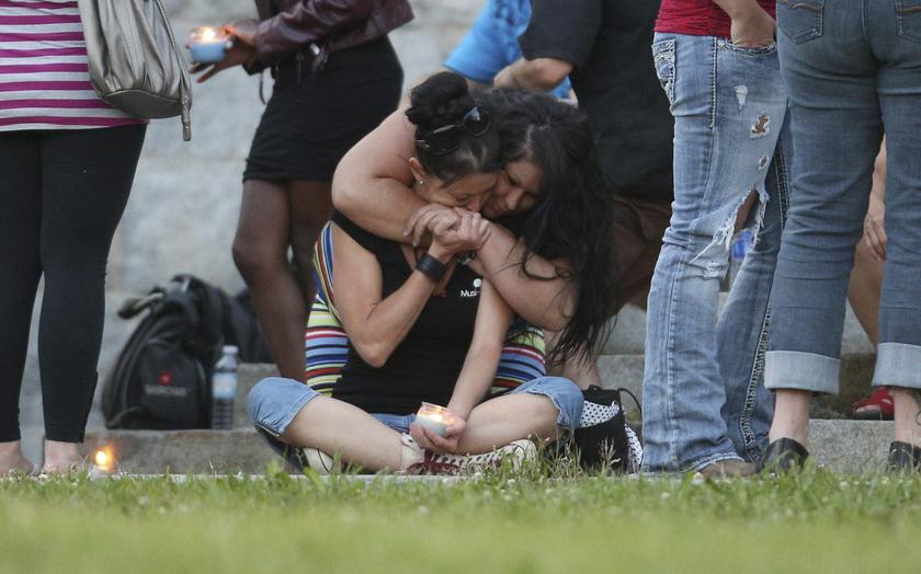 A woman consoles her friend during a candlelight vigil at the Sainte-Agnes church in Lac-Megantic, Quebec July 12, 2013. u00e2u20acu201c Reuters pic